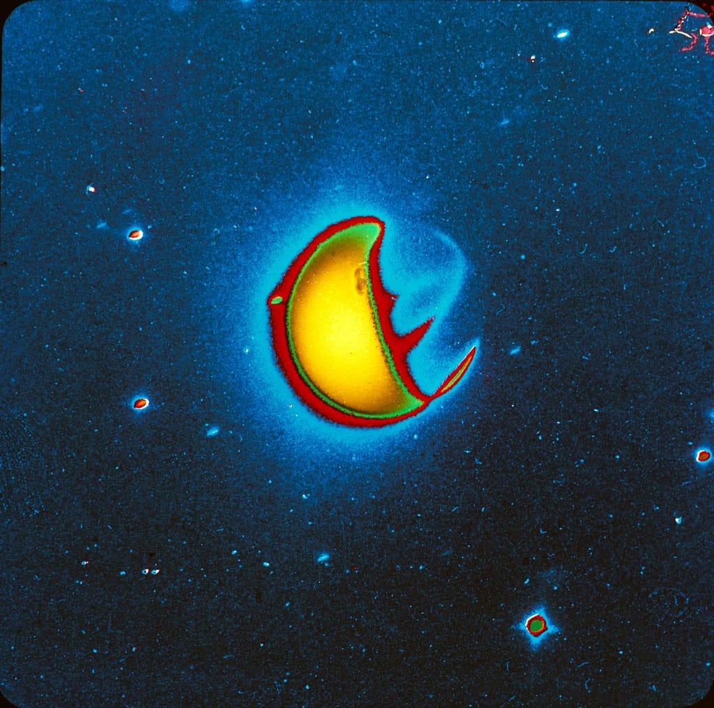 S72-40821 (21 April 1972) --- An artificially reproduced color enhancement of a ten-minute far-ultraviolet exposure of Earth, taken with a filter which blocks the glow caused by atomic hydrogen but which transmits the glow caused by atomic oxygen and molecular nitrogen. Note that airglow emission bands are visible on the night side of Earth, one roughly centered between the two polar auroral zones and one at an angle to this extending northward toward the sunlit side of Earth. The UV camera was operated by astronaut John W. Young on the Apollo 16 lunar landing mission. It was designed and built at the Naval Research Laboratory, Washington, D.C. EDITOR'S NOTE: The photographic number of the original black & white UV camera photograph, from which this artificially reproduced version was made, is AS16-123-19657.
Date Created:1972-06-06