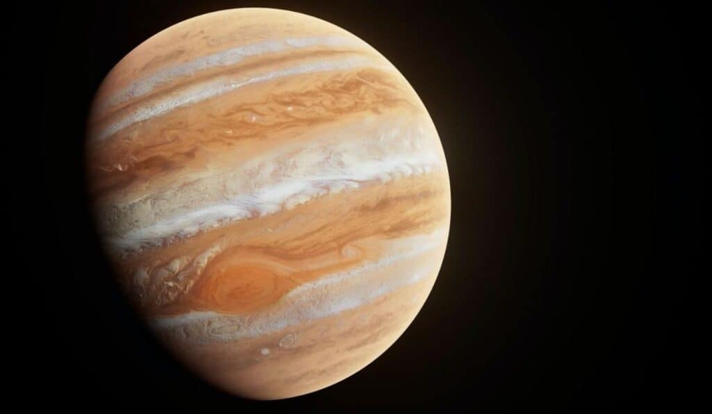 Júpiter, destacando a icônica Grande Mancha Vermelha, uma enorme tempestade persistente que ocupa uma grande área no hemisfério sul do planeta. A imagem mostra a rotação das nuvens em diferentes tons de laranja, marrom e branco, com a mancha vermelha visível no centro, contrastando com o resto da atmosfera de Júpiter.