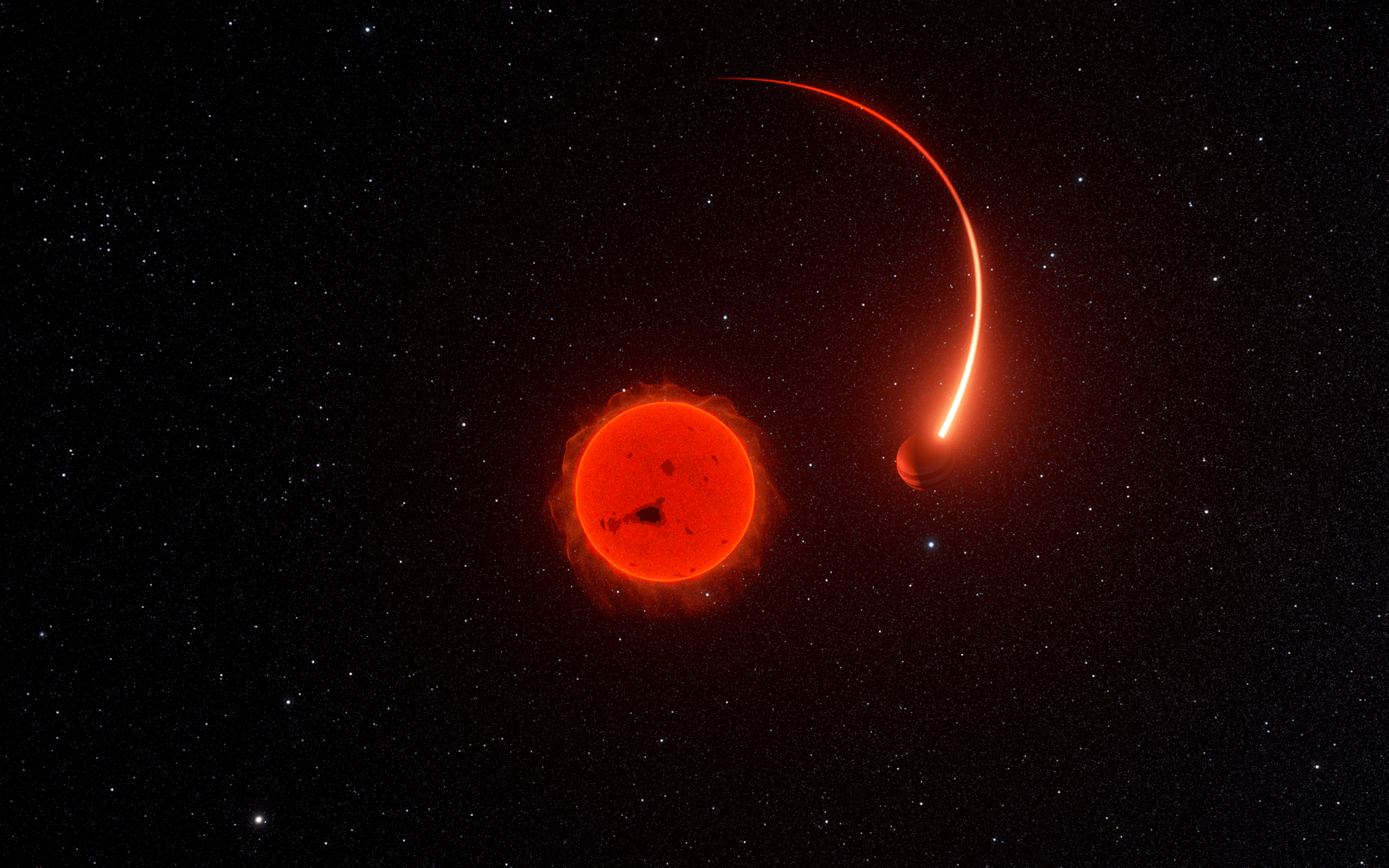 Descrição da imagem: Esta imagem mostra uma estrela vermelha como um globo flamejante no meio de um céu escuro repleto de estrelas. A estrela apresenta manchas escuras em sua superfície e erupções ao seu redor. À direita da estrela, há um objeto menor e arredondado, cuja lateral esquerda é mais iluminada que a direita. O objeto possui duas faixas. De sua parte traseira, parte um feixe vermelho em forma de meia elipse, dando a impressão de que o objeto está em movimento ao redor da estrela.