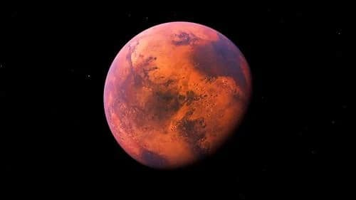 Imagem de Marte com detalhes visíveis de sua superfície vermelha e características geológicas, como montanhas e vales. O planeta é rodeado por uma atmosfera fina e tons de vermelho predominam, destacando o contraste com o céu escuro ao fundo.