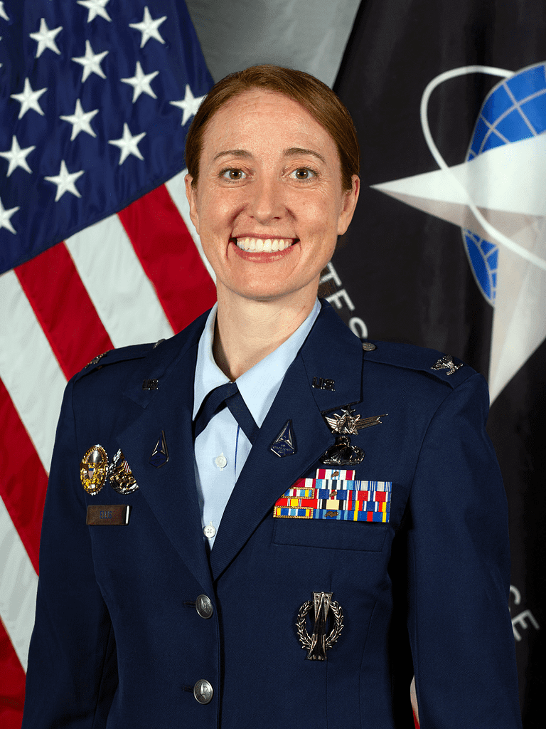 Ellen Ellis, from North Kingstown, Rhode Island, is a colonel and an acquisitions officer in the United States Space Force. She currently serves as a senior materiel leader in the National Reconnaissance Office (NRO) Communications Systems Directorate. She is responsible for fielding commercial cloud and traditional information technology hosting solutions and building modernized data centers for the NRO. She previously served as an Intercontinental Ballistic Missile operations officer and GPS satellite engineer, and she also developed geospatial intelligence payloads and ground processing systems.