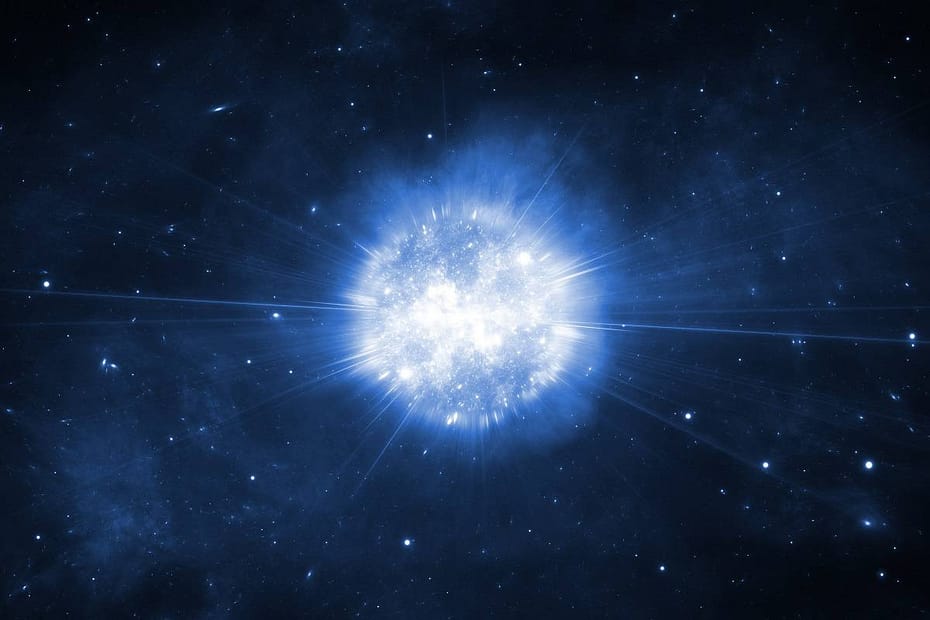 explosão de supernova no espaço, com nuvens de gás e poeira brilhando em tons vibrantes de azul, vermelho e laranja. A intensa liberação de energia ilumina a escuridão do cosmos, criando um espetáculo cósmico de luz e cor.