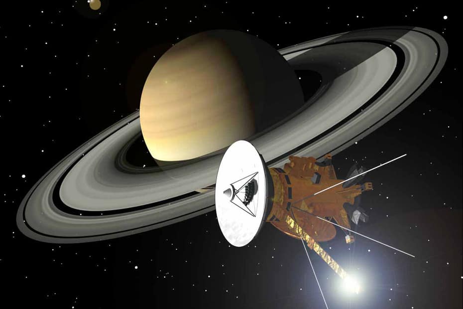 Impressão artística da nave Cassini-Huygens (NASA/ESA/ASI) orbitando Saturno e seus magníficos anéis. O brilho de luz atrás da haste do magnetômetro, na parte inferior da espaçonave, é um reflexo do Sol.