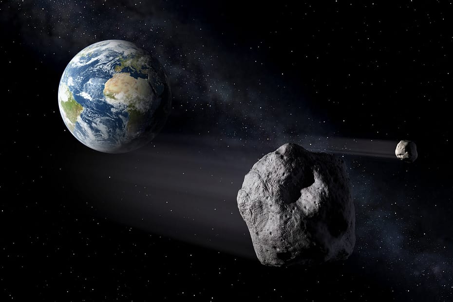 Ilustração mostrando a Terra vista do espaço com um asteroide se aproximando em sua direção, representando o conceito de defesa planetária e monitoramento de objetos próximos à Terra. Créditos: ESA.